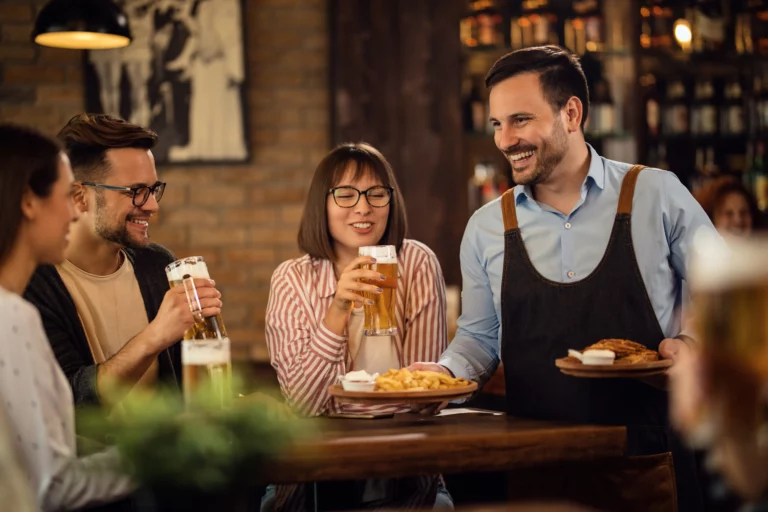 server bringing food to table in restaurant