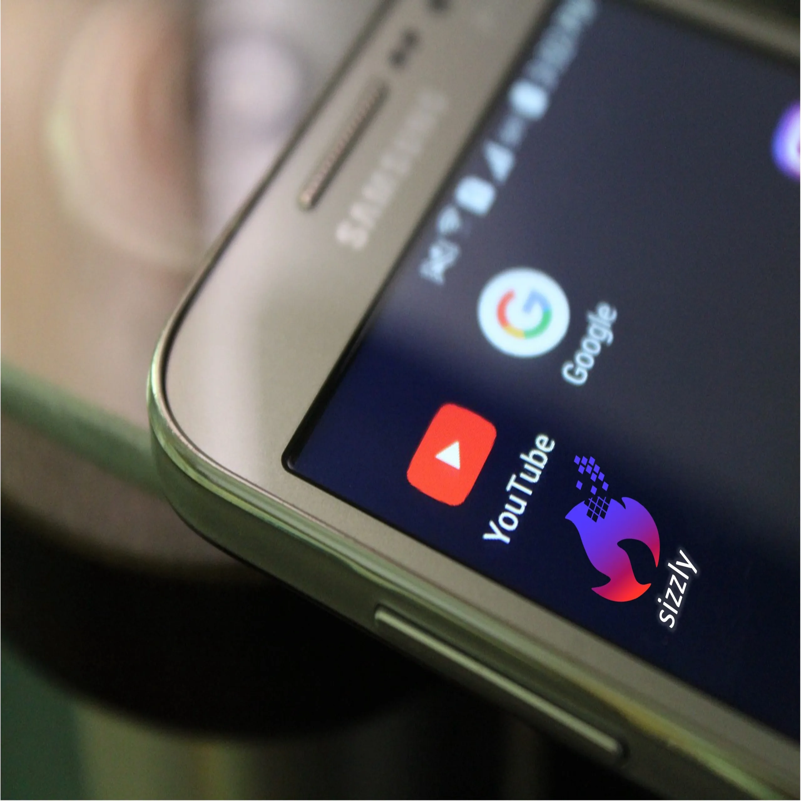 phone home screen with apps including sizzly app