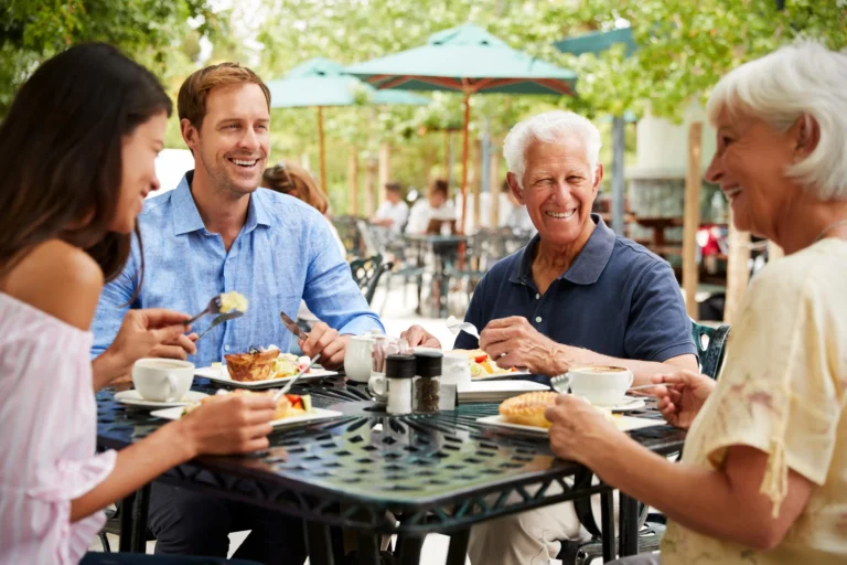 family eating outside of restaurant
